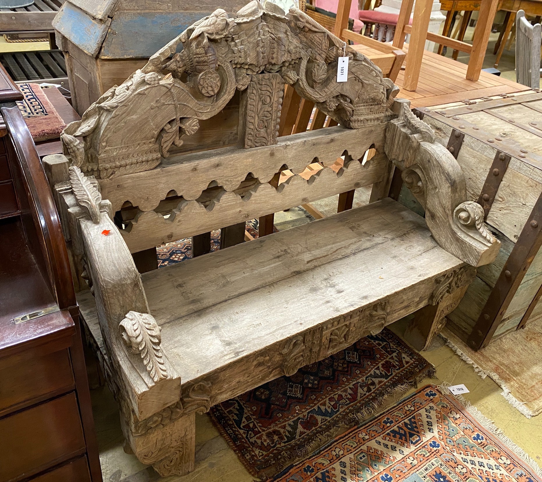 An Indonesian bleached carved hardwood bench seat, length 124cm, depth 50cm, height 111cm